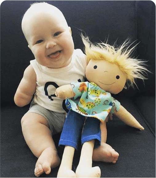 Baby playing with doll